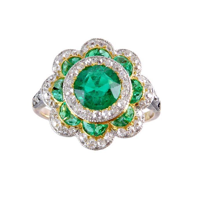 Early 20th century emerald and diamond flowerhead cluster ring c.1915, the circular facetted emerald of approximately 0.55ct, | MasterArt